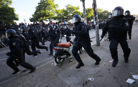 German riot police run towards protesters during demonstrations. REUTERS/Kai Pfaffenbach