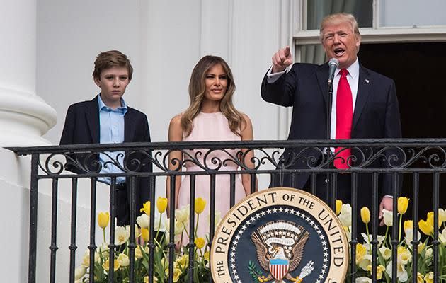 Barron is pictured on the balcony of the White House with his father and mother. Photo: Getty Images