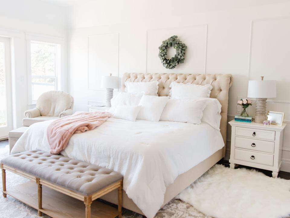 bedroom nightstand wreath quilted headboard white lamp rug