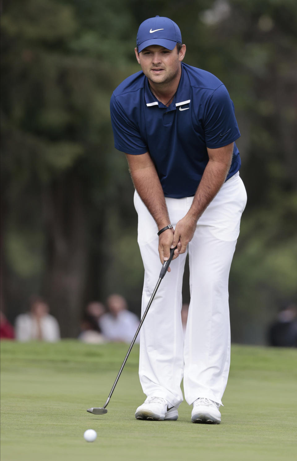 Patrick Reed of the United States follows his putt on the 18th green during the second round for the WGC-Mexico Championship golf tournament, at the Chapultepec Golf Club in Mexico City, Friday, Feb. 21, 2020. (AP Photo/Fernando Llano)