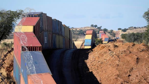 PHOTO: A long row of double-stacked shipping containers provide a new wall between the United States and Mexico in the remote section area of San Rafael Valley, Ariz., Dec. 8, 2022. (Ross D. Franklin/AP)