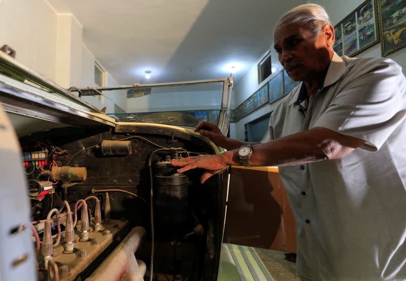 Sayed Sima, a 70-years-old Egyptian collecting vintage cars checks the 120-year-old American automobile "1900 Auburn" being in his store and his own exhibition of old cars in the Giza suburb of Abu Rawash