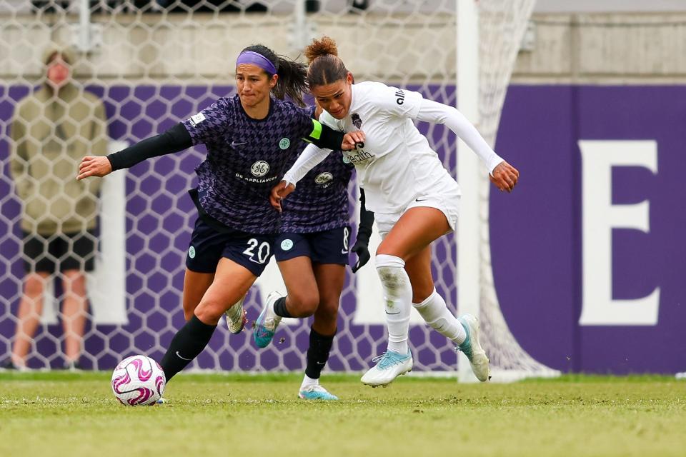 Racing Louisville FC defender Abby Erceg (20) fights for the ball against Washington Spirit forward Trinity Rodman (2) during the second half at Lynn Family Stadium on April 1, 2023.