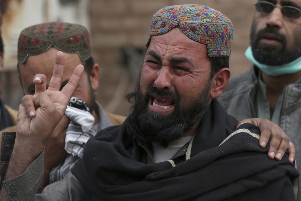 A family member of a police officer, who was killed in Monday's suicide bombing, weeps as he and others take part in a rally denouncing militant attacks and demanding peace in the country, in Peshawar, Pakistan, Friday, Feb. 3, 2023. (AP Photo/Muhammad Sajjad)