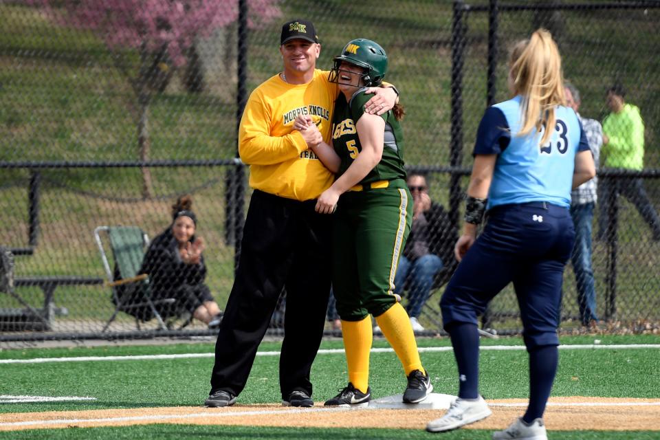 Morris Knolls head coach Keith Heinemann hugs Jess Arminio after a stolen base. IHA defeats Morris Knolls 8-5 to win the first-ever NFCA New Jersey Leadoff Classic on Sunday, April 7, 2019, in Newark. This first Leadoff Classic is in honor of Anthony LaRezza, the former Immaculate Heart Academy coach who passed away in February 2016 after battling cancer.