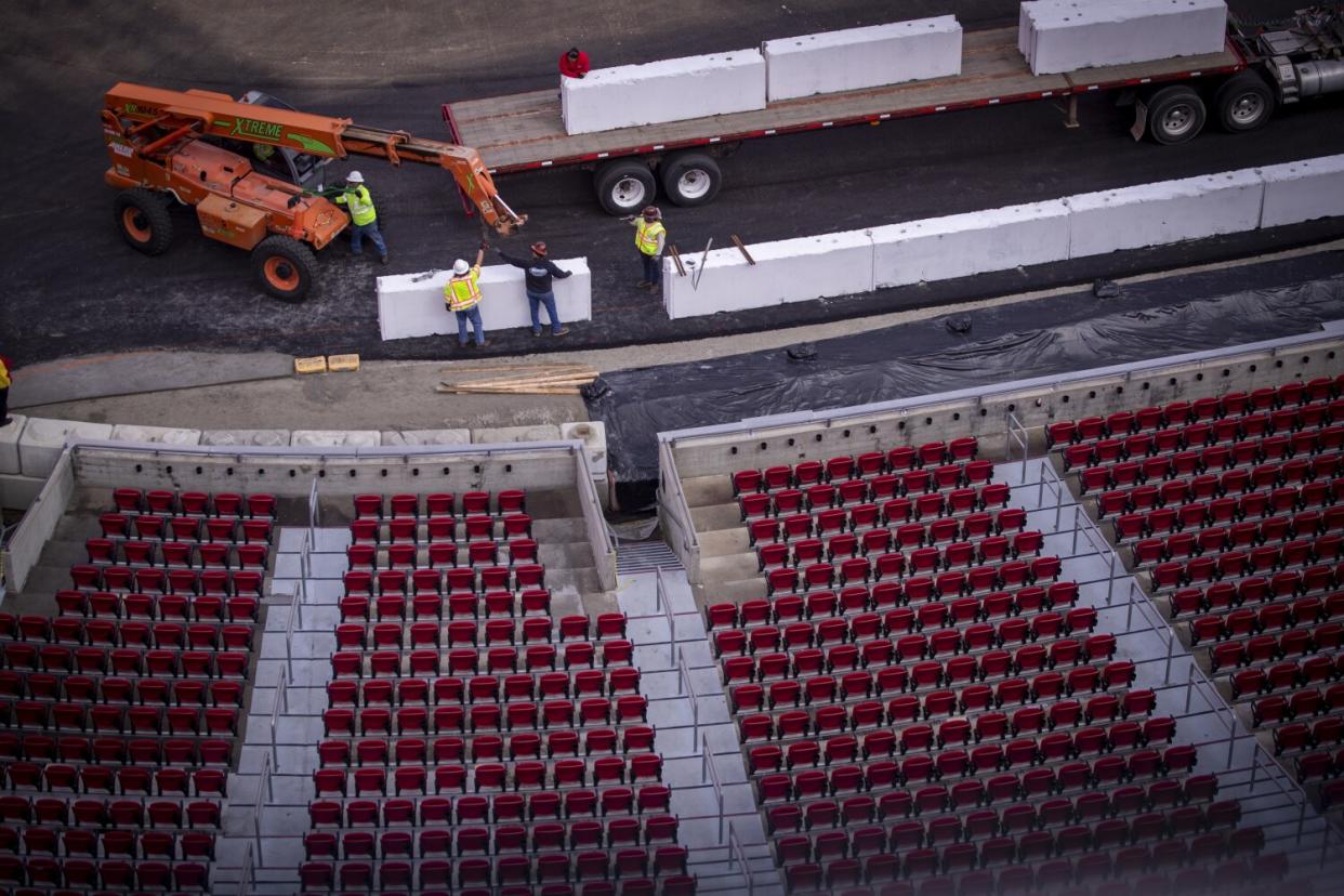 Construction crews transform the Coliseum from a football stadium to a quarter-mile short track NASCAR exhibition race track.