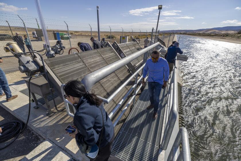 Lancaster, CA - October 23: People view the new turnout facility from the California Aqueduct during the opening of the new High Desert Water Bank, where Metropolitan Water District is starting to store water underground for cities across Southern California in Lancaster Monday, Oct. 23, 2023. The district is holding an opening for the new facility, where imported water from the State Water Project soaks into the groundwater basin. Officials say the project will help the region prepare for the effects of climate change. (Allen J. Schaben / Los Angeles Times)