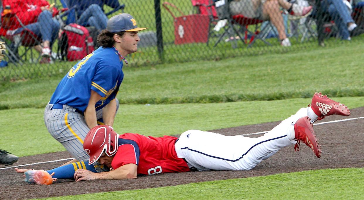 Mitchell's Simon Gaines (3) gets the out on Bedford North Lawrence runner Gavin Pederson (28) on Friday, May 3, 2024.