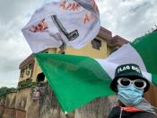Adebanjo Akinwunmi raises his flags as Nigeria marks the one anniversary of the EndSARS anti-police brutality protests in Lagos