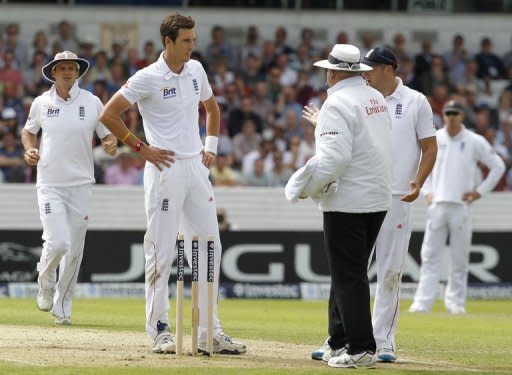 Umpire Steve Davis (right) talks to England's Steven Finn after he calls a dead ball during the second international test cricket match between England and South Africa at Headingley Carnegie in Leeds. England endured a frustrating morning after sending South Africa in to bat on the first day of the second Test at Headingley