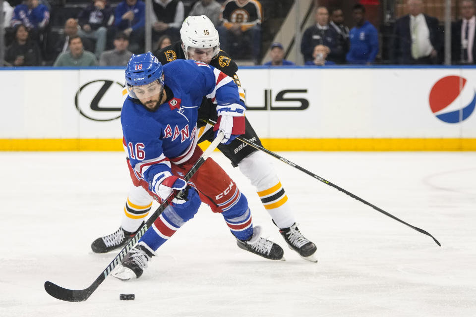 New York Rangers' Vincent Trocheck (16) fights for control of the puck with Boston Bruins' Pavel Zacha (18) during the first period of an NHL hockey game Thursday, Jan. 19, 2023, in New York. (AP Photo/Frank Franklin II)