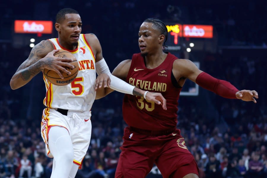 Atlanta Hawks guard Dejounte Murray (5) drives against Cleveland Cavaliers forward Isaac Okoro (35) during the first half of an NBA basketball game Saturday, Dec. 16, 2023, in Cleveland. (AP Photo/Ron Schwane)