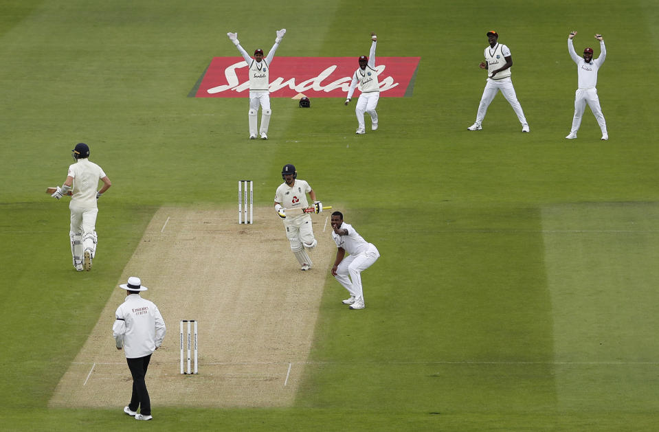 West Indies' Shannon Gabriel, foreground right, and teammates appeal for the wicket of England's Rory Burns, center right with bat, during the second day of the first cricket Test match between England and West Indies, at the Ageas Bowl in Southampton, England, Thursday, July 9, 2020. (Adrian Dennis/Pool via AP)