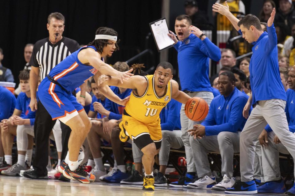 Missouri's Nick Honor, right, drives past Florida's Walter Clayton Jr. during the first half of an NCAA college basketball game Saturday, Jan. 20, 2024, in Columbia, Mo. (AP Photo/L.G. Patterson)