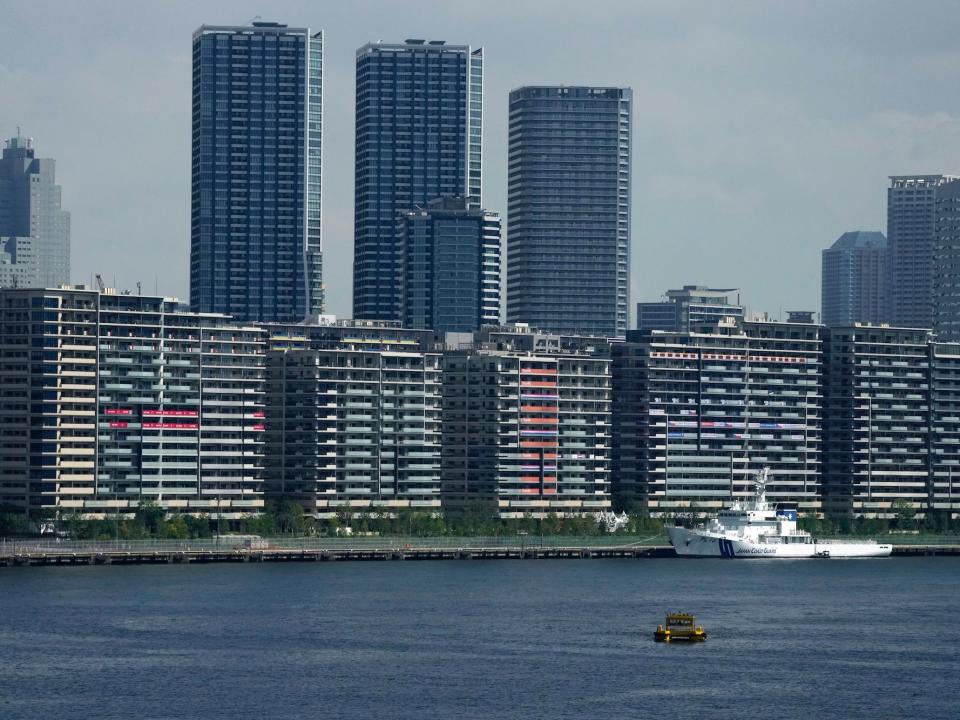 The Tokyo Olympics athlete's village towers across the water.