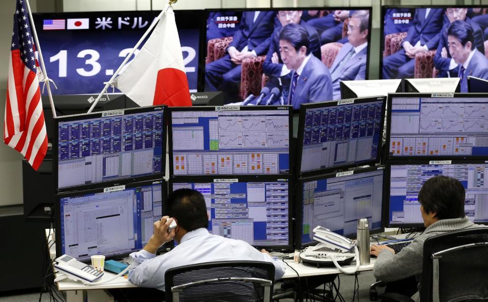 Money traders watch computer screens with the day's exchange rate between Japanese yen and the U.S. dollar at a foreign exchange brokerage in Tokyo, Wednesday, Feb. 1, 2017. Japanese officials have rejected U.S. President Donald Trump's suggestion that Tokyo is seeking to weaken the yen against the U.S. dollar to gain a trade advantage. (AP Photo/Shizuo Kambayashi)