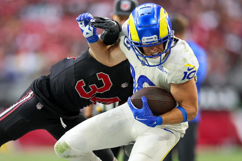 GLENDALE, ARIZONA - NOVEMBER 26: Jalen Thompson #34 of the Arizona Cardinals tackles Cooper Kupp #10 of the Los Angeles Rams during the third quarter at State Farm Stadium on November 26, 2023 in Glendale, Arizona. (Photo by Christian Petersen/Getty Images)