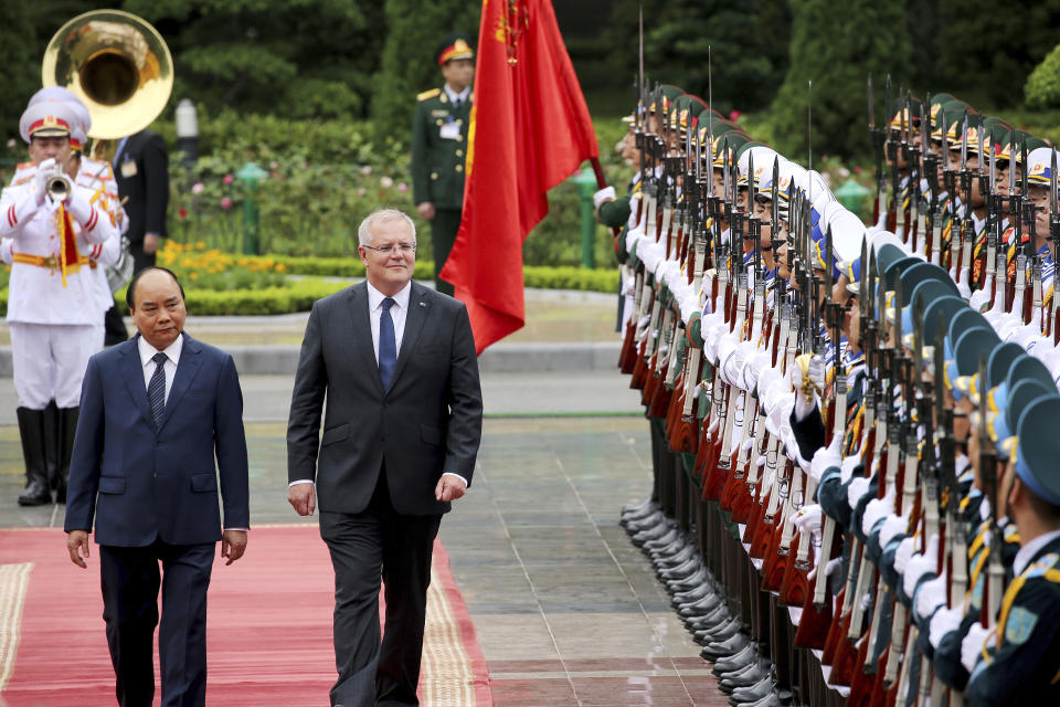 Australian Prime Minister Scott Morrison, second from left, with his Vietnamese counterpart Nguyen Xuan Phuc reviews an honor guard during a welcome ceremony at the Presidential Palace in Hanoi, Vietnam, Friday, Aug. 23, 2019. Morrison is on a three-day official visit to Vietnam. (AP Photo/Duc Thanh)
