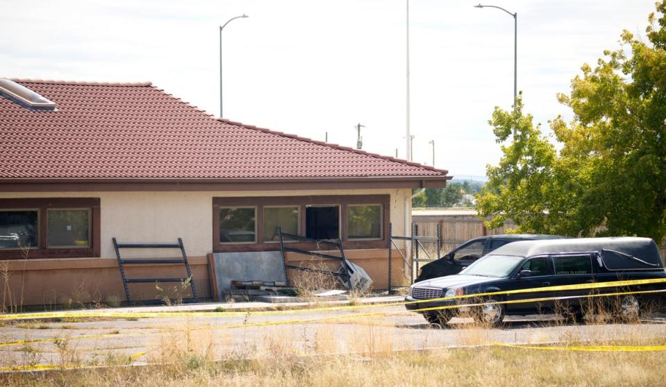 A hearse and van sit outside the Return to Nature Funeral Home on October 6, 2023, in Penrose, Colorado; the owners were arrested after authorities discovered nearly 200 decaying bodies at the property (Copyright 2023 The Associated Press. All rights reserved.)