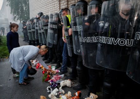 Policemen stand guard during a protest following the killing of a boy in Pereiaslav-Khmelnytskyi