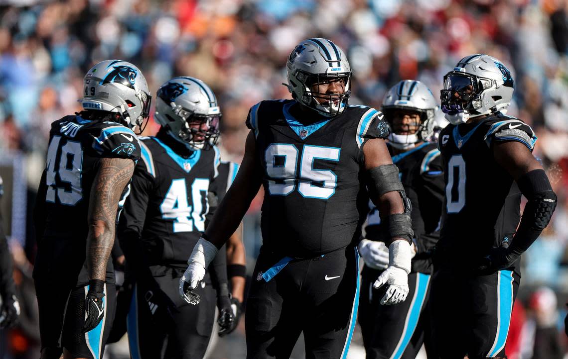 Carolina Panthers defensive tackle Derrick Brown, center, celebrates a sack against the Tampa Bay Buccaneers at the Bank of America Stadium in Charlotte, N.C., on Sunday, January 7, 2024.