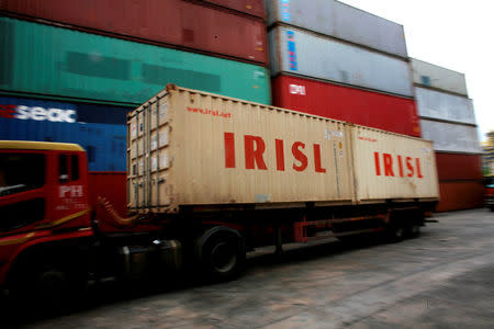 A truck carrying Islamic Republic of Iran Shipping Lines (IRISL) containers arrives a depot in northern Singapore February 4, 2012. REUTERS/Thomas White/File Photo