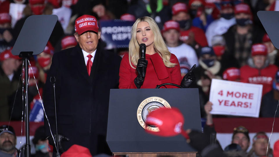  Donald Trump listens as his daughter Ivanka Trump speaks during a campaign rally at the Kenosha Regional Airport on November 2.