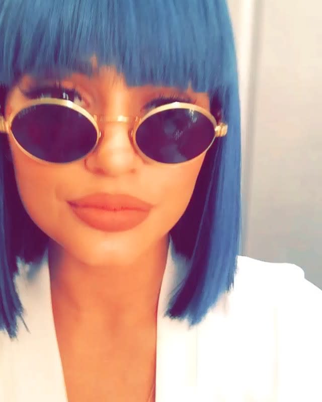 Kylie Jenner is doing her own thing, and she doesn't care what people think -- not even her half-sister Kourtney Kardashian. On Friday night, Kylie rocked a blue wig with short bangs while hanging out with her boyfriend Tyga and Kourtney's ex, Scott Disick, at the West Hollywood nightclub 1 OAK. Splash News The 18-year-old reality star was photographed with Tyga and Scott outside the club, wearing dark, round shades and trying to stay out of the paparazzi pics. <strong>WATCH: Tyga Shares Super Sexy Photo of Kylie Jenner on Her 18th Birthday </strong> Kylie kept up the blue wig look on Saturday night as well when she hit the town with her friends, including model Chantell Jeffries. The blue theme was also evident in her wardrobe, as she sported a button-down denim top and some ripped denim short-shorts that showed a flash of her butt. Splash News The <em>Keeping Up With the Kardashians</em> star also shared a pic of her Louise Brooks-style wig on Instagram on Friday. It's hard to make short blue wigs actually work but Kylie manages to pull it off . WATCH: Kylie Jenner Models Tyga's Boxer Briefs on Snapchat There also doesn't seem to be any bad blood between Kylie and Kourtney after the youngest Jenner sister hung out with Scott. On Sunday night, the sisters posed with mom, Kris Jenner, at the 2015 MTV Video Music Awards. Getty Images One thing she hasn't been pulling off is responsible water conservation. Kylie and her boyfriend were reportedly cited for water over consumption at their home in draught-starved California. 