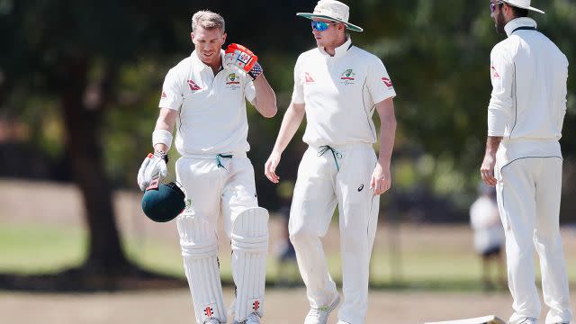 Warner points to his neck. Image: Getty