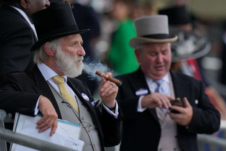 A racegoers smoke a cigar on the second day of the Royal Ascot horserace.