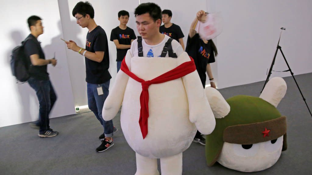 A worker wears a Xiaomi marketing suit.