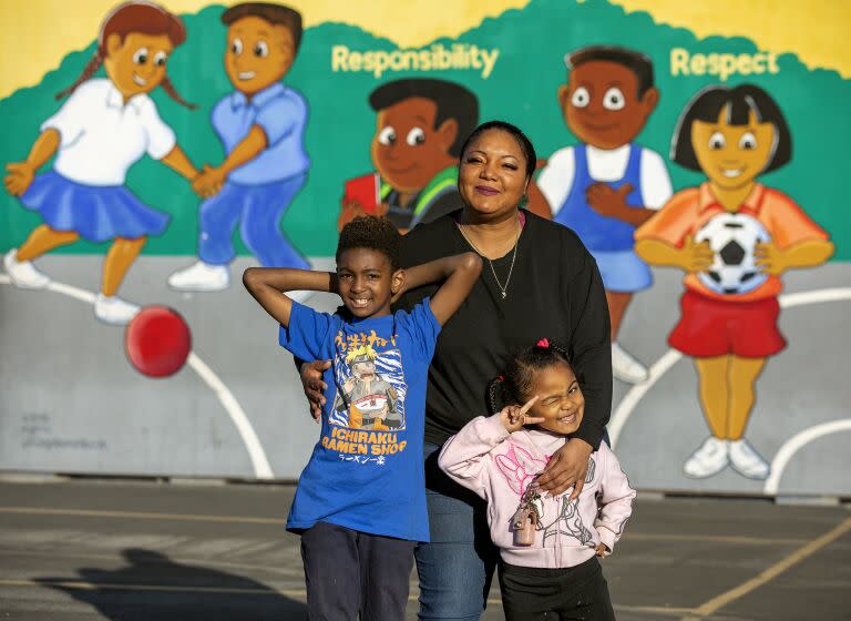 LOS ANGELES, CA-FEBRUARY 3, 2023:Antoinnyca Daniels, 36, who lives in a shelter in South Los Angeles with her son Aiden Abiy, 8, and daughter Amore Daniels, 4, is photographed with her kids at Compton Ave. Elementary School STEAM Academy in Los Angeles, where her son attends and is in the 3rd grade. Her daughter is in pre-school at 112th St. School in Los Angeles. (Mel Melcon / Los Angeles Times)