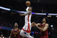 Houston Rockets guard Jalen Green (4) shoots against Cleveland Cavaliers forward Evan Mobley (4) and center Jarrett Allen, right, during the second half of an NBA basketball game, Sunday, March 26, 2023, in Cleveland. (AP Photo/Ron Schwane)