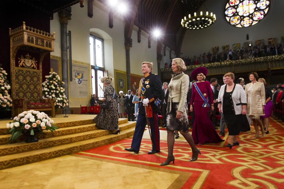 Dutch Queen Beatrix, at left, walking up the stairs, arrives together with Crown Prince Willem Alexander centre left, and his wife Princess Maxima, right, to formally open the new parliamentary year with a speech outlining the government's plans for its 2013 budget, in The Hague, Netherlands, Tuesday, Sept. 18, 2012. The Netherlands' Queen Beatrix underlined her country's commitment to the euro during her annual address to Parliament about the national budget on Tuesday, and made it clear the country will continue to pursue "austerity" policies in response to Europe's debt crisis. (AP Photo/Vincent Jannink)