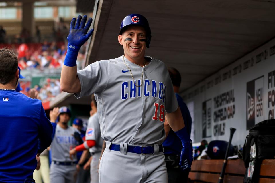Chicago Cubs' Frank Schwindel waves in the dugout after hitting a two-run home run against the Cincinnati Reds on May 24 in Cincinnati.