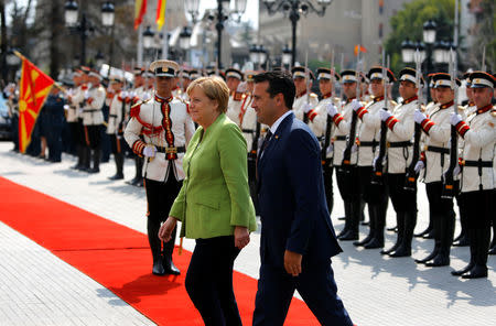 Macedonian Prime Minister Zoran Zaev and German Chancellor Angela Merkel attend a welcome ceremony in Skopje, Macedonia September 8, 2018. REUTERS/Ognen Teofilovski