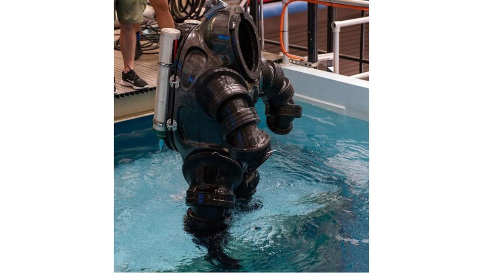 A new dive suit, being raised out of a pool after a concept demonstration, at the U.S. Navy Experimental Diving Unit in early February, would enhance range of motion and allow the user to swim independent of propulsion systems. (Anthony Powers/Navy)