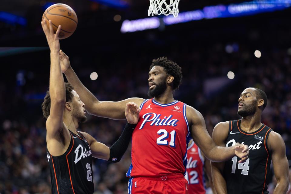 Philadelphia 76ers center Joel Embiid (21) reacts with Detroit Pistons guard Cade Cunningham (2) after a score during the second quarter at Wells Fargo Center in Philadelphia on Friday, Dec. 15, 2023.