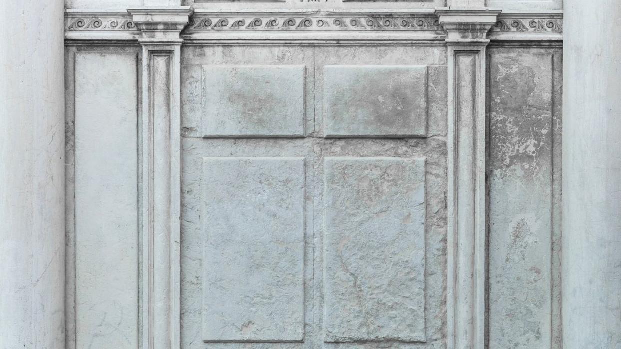 texture of ancient stone gray concrete wall with geometric ornament and columns background with copy space