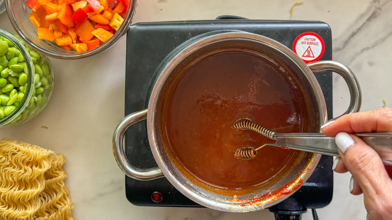 stirring sauce in pot