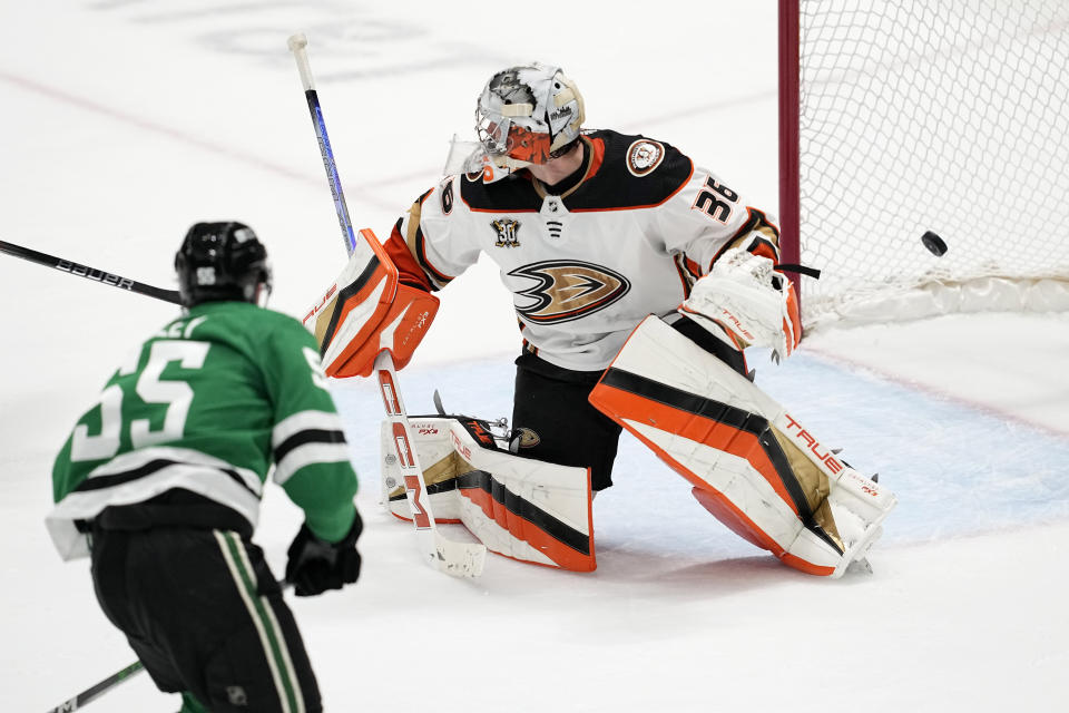 Dallas Stars defenseman Thomas Harley (55) scores against Anaheim Ducks goaltender John Gibson (36) in overtime of an NHL hockey game in Dallas, Thursday, Jan. 25, 2024. (AP Photo/Tony Gutierrez)