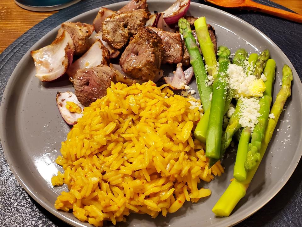 dinner plate with rice, meat, and asparagus