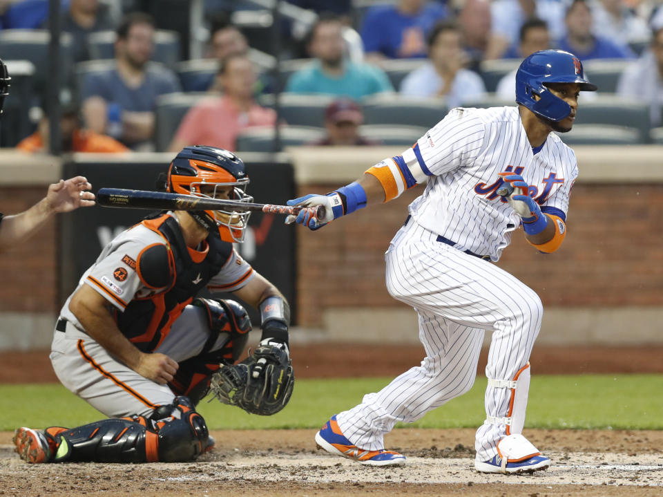 New York Mets' Robinson Cano, back in the lineup after a stint on the injured list, watches his groundout with the bases loaded during the third inning of the team's baseball game against the San Francisco Giants, Wednesday, June 5, 2019, in New York. Giants catcher Aramis Garcia is at left. (AP Photo/Kathy Willens)