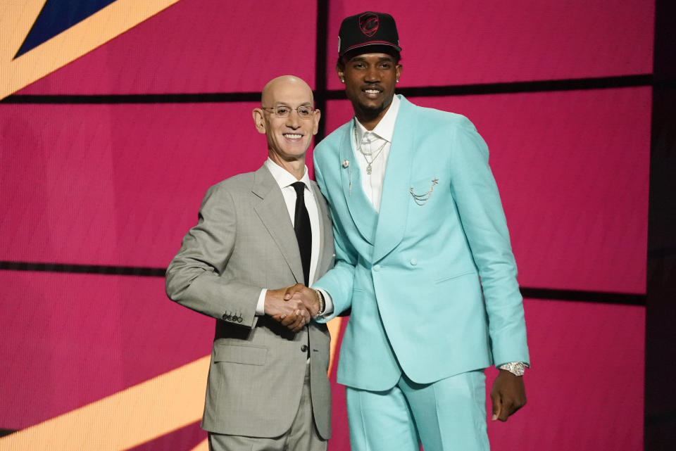 Evan Mobley, right, poses for a photo with NBA Commissioner Adam Silver after being selected third overall by the Cleveland Cavaliers during the NBA basketball draft, Thursday, July 29, 2021, in New York. - Credit: AP