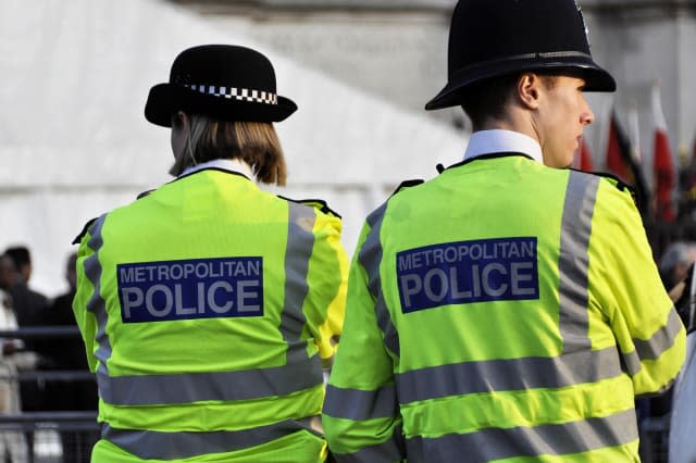 LONDON, UK - MARCH 12: Two police officers outside Westminster Abbey where Queen Elizabeth II attends the Commonwealth Day cerem