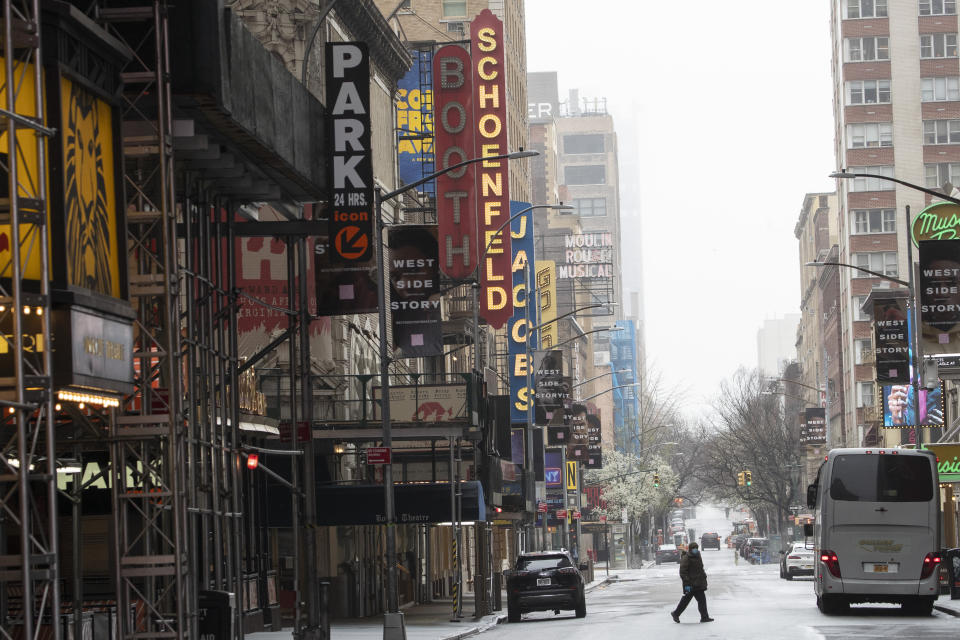 FILE - A pedestrian makes his way across 46th Street in New York's Times Square on March 29, 2020. A new survey by The Actors Fund illustrates the depths of need created by the COVID-19 pandemic in the arts community. It reveals financial hardship, food insecurity and lost housing. (AP Photo/Mary Altaffer, File)