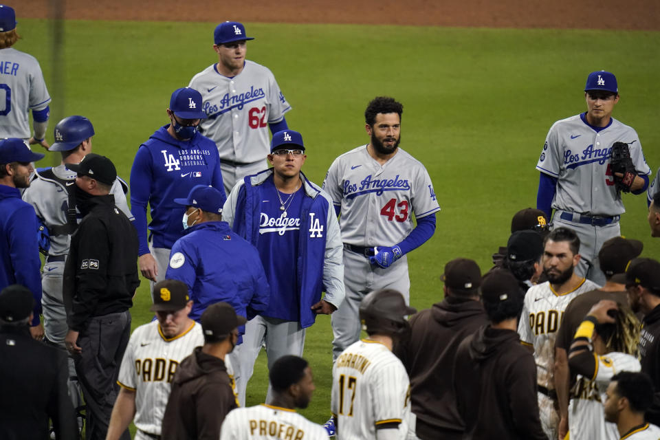 Members of the Los Angeles Dodgers and the San Diego Padres approach each other after San Diego Padres' Jorge Mateo was hit by a pitch from Los Angeles Dodgers starting pitcher Dennis Santana during the tenth inning of a baseball game Friday, April 16, 2021, in San Diego. (AP Photo/Gregory Bull)