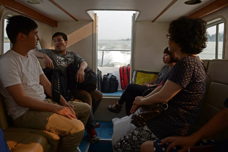 Visitors take a Kings Romans casino shuttle boat as they cross the Mekong river from Thailand to Ton Pheung, a special economic zone set in northwestern Laos along the Mekong river, at the border with Thailand and Myanmar