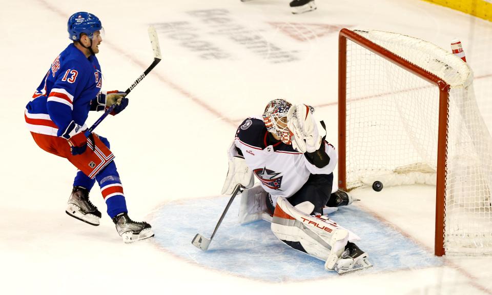 New York Rangers left wing Alexis Lafreniere (13) scores the the winning goal against Columbus Blue Jackets goaltender Elvis Merzlikins, right, during a shootout of an NHL hockey game, Sunday, Nov. 12, 2023, in New York.