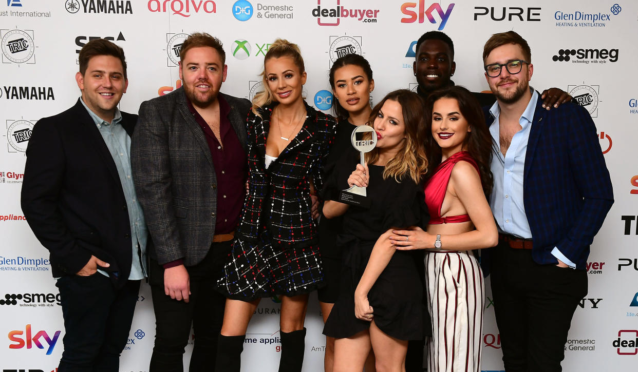 Amber Davies (second right), Montana Brown (centre left), Olivia Attwood (third left), Caroline Flack (centre right), Ian Sterling (far right) and Marcel Somerville with the Reality Programme Award for Love Island at during the 2018 TRIC Awards at the Grosvenor House Hotel, London. (Photo by Ian West/PA Images via Getty Images)